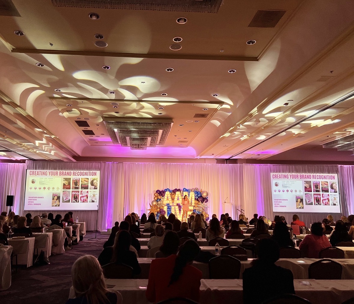 Victoria Racca speaking on stage to beauty professionals
